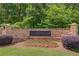 Community sign surrounded by professionally landscaped grounds and seasonal flowers at 1657 Hampton Woods Way, Lawrenceville, GA 30043