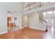 Open foyer area featuring hardwood floors, staircase, and access to the kitchen at 1657 Hampton Woods Way, Lawrenceville, GA 30043