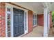 Covered front porch featuring brick pillars and a stylish front door with sidelights at 1657 Hampton Woods Way, Lawrenceville, GA 30043