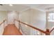 Hallway with wood floors, banister and decorative ceiling medallion at 1657 Hampton Woods Way, Lawrenceville, GA 30043