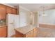 Kitchen featuring wood cabinets, granite counters, island, and stainless steel appliances at 1657 Hampton Woods Way, Lawrenceville, GA 30043