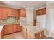 Kitchen with wood cabinets, granite counters, island, and stainless steel appliances at 1657 Hampton Woods Way, Lawrenceville, GA 30043