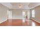 Spacious main bedroom with hardwood floors, tray ceiling and neutral paint at 1657 Hampton Woods Way, Lawrenceville, GA 30043