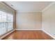 Bright room with hardwood floors, white trim, and a large window at 1657 Hampton Woods Way, Lawrenceville, GA 30043