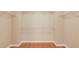 A large walk-in closet with wood floor and plenty of shelving space at 1657 Hampton Woods Way, Lawrenceville, GA 30043