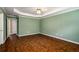 Large bedroom featuring a tray ceiling, hardwood floors, and neutral paint at 1978 Elmwood Cir, Snellville, GA 30078
