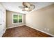 Bedroom with hardwood floors, large window, and ceiling fan at 1978 Elmwood Cir, Snellville, GA 30078