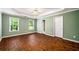 Spacious bedroom featuring hardwood floors, ceiling fan, and natural light at 1978 Elmwood Cir, Snellville, GA 30078