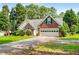 Beautiful home with brick and siding, a well-manicured lawn, green door, and two-car garage at 1978 Elmwood Cir, Snellville, GA 30078
