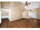 Spacious living room featuring dark wood floors, a ceiling fan, and an archway leading to the front door at 1978 Elmwood Cir, Snellville, GA 30078