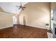 Spacious living room with dark wood floors, ceiling fan, fireplace, and a high vaulted ceiling at 1978 Elmwood Cir, Snellville, GA 30078