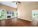 Open living room featuring wood floors, fireplace, large windows, and a ceiling fan at 1978 Elmwood Cir, Snellville, GA 30078