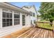 Large wooden deck attached to a white house with green shutters and large windows at 524 Stephens Point Se Dr, Lawrenceville, GA 30045