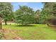 Expansive backyard featuring a large tree, offering ample space for recreation and outdoor activities at 524 Stephens Point Se Dr, Lawrenceville, GA 30045