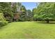 Lush green backyard with mature trees, providing privacy and a serene outdoor space at 524 Stephens Point Se Dr, Lawrenceville, GA 30045