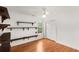 Bedroom with wood floors, ceiling fan, closet, and decorative shelving at 524 Stephens Point Se Dr, Lawrenceville, GA 30045