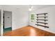 Cozy bedroom features wood floors, natural light, and custom shelving at 524 Stephens Point Se Dr, Lawrenceville, GA 30045