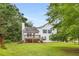 Rear exterior view of a two-story home with a deck and a well-maintained lawn at 524 Stephens Point Se Dr, Lawrenceville, GA 30045