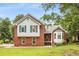 Traditional two-story home with brick facade and green shutters surrounded by mature trees at 524 Stephens Point Se Dr, Lawrenceville, GA 30045