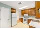 Functional kitchen featuring white appliances, wood cabinets, and ample counter space at 524 Stephens Point Se Dr, Lawrenceville, GA 30045