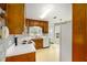 Well-lit kitchen with classic wood cabinetry, white appliances, and a window over the sink at 524 Stephens Point Se Dr, Lawrenceville, GA 30045