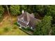 Aerial view of a two-story home with a well-manicured lawn, complemented by mature trees and lush landscaping at 8601 Flint Hill Rd, Douglasville, GA 30135