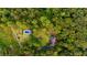 Aerial view of home featuring a pool, pool house, expansive yard, all surrounded by lush trees at 8601 Flint Hill Rd, Douglasville, GA 30135