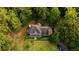 Aerial view of a charming two-story home surrounded by lush greenery, highlighting its peaceful and private setting at 8601 Flint Hill Rd, Douglasville, GA 30135