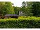 Well-manicured backyard with mature trees frames a charming home, offering privacy and a serene setting at 8601 Flint Hill Rd, Douglasville, GA 30135
