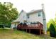 Back exterior of home featuring siding, deck, and a large sloping yard at 8601 Flint Hill Rd, Douglasville, GA 30135