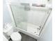 Tiled bathtub and shower combination with sliding glass doors in neutral bathroom at 8601 Flint Hill Rd, Douglasville, GA 30135