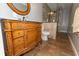 Bathroom features an ornate vanity with dark countertop, oval mirror, and step-in glass shower at 8601 Flint Hill Rd, Douglasville, GA 30135