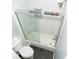 Tiled bathtub and shower combination with sliding glass doors in neutral bathroom at 8601 Flint Hill Rd, Douglasville, GA 30135