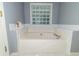 Relaxing bathtub with tile surround and glass block window at 8601 Flint Hill Rd, Douglasville, GA 30135