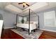 Spacious bedroom features trey ceiling, wood floors, a ceiling fan and a modern canopy bed at 8601 Flint Hill Rd, Douglasville, GA 30135
