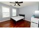 Neutral bedroom features wood floors, two large windows and a ceiling fan at 8601 Flint Hill Rd, Douglasville, GA 30135