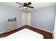 Bedroom features hardwood floors, ceiling fan, and grey color scheme at 8601 Flint Hill Rd, Douglasville, GA 30135