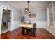Elegant dining room featuring hardwood floors, wainscoting, a modern chandelier and neutral wall color at 8601 Flint Hill Rd, Douglasville, GA 30135