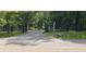 An open black rail fence leads to a secluded driveway entrance off the main road at 8601 Flint Hill Rd, Douglasville, GA 30135