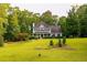 Beautifully landscaped home with a sprawling lawn and mature trees at 8601 Flint Hill Rd, Douglasville, GA 30135