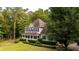 Charming two-story home with a welcoming front porch, surrounded by lush landscaping and mature trees at 8601 Flint Hill Rd, Douglasville, GA 30135