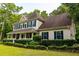 Attractive home featuring a covered front porch and lush greenery at 8601 Flint Hill Rd, Douglasville, GA 30135
