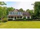 Traditional two-story home with a welcoming front porch and lush green lawn at 8601 Flint Hill Rd, Douglasville, GA 30135