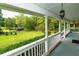 Spacious front porch perfect for relaxation, featuring white railing and views of the well-maintained grounds at 8601 Flint Hill Rd, Douglasville, GA 30135