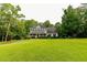 Exterior facade of home with front lawn, porch, and mature trees at 8601 Flint Hill Rd, Douglasville, GA 30135