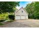 Detached three-car garage with a paved driveway and convenient side entrance at 8601 Flint Hill Rd, Douglasville, GA 30135