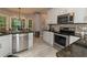 Spacious kitchen featuring stainless steel appliances, granite countertops, tile backsplash and breakfast nook at 8601 Flint Hill Rd, Douglasville, GA 30135