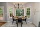Well-lit breakfast nook offering backyard views, hardwood floors, and modern light fixture at 8601 Flint Hill Rd, Douglasville, GA 30135