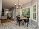 Bright breakfast nook with large windows, wood floors, and a view to the backyard deck and green landscape at 8601 Flint Hill Rd, Douglasville, GA 30135