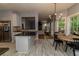 Open kitchen with granite countertops, stainless steel appliances, eat in area, and an adjacent living space at 8601 Flint Hill Rd, Douglasville, GA 30135